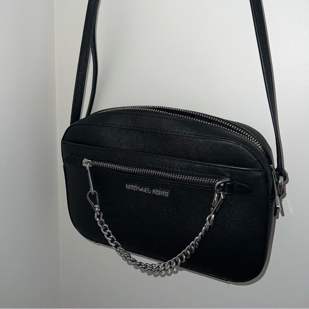 Michael Kors (MK) cross body with silver metal accents.